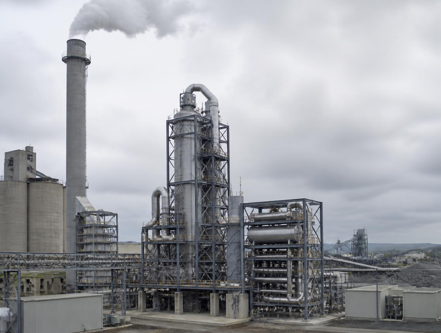 Unité de captage de CO₂ installée le long d'une cimenterie : colonne d'absorption, échangeurs et cheminée
